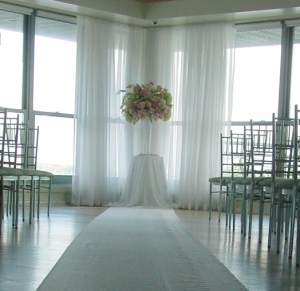 A white aisle runner led the bride and groom into this light hearte oasis which was their ceremony