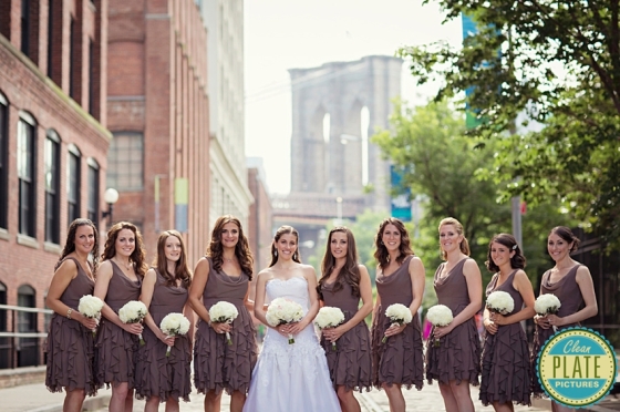 Bridesmaids wearing gray dresses and white mum bouquets