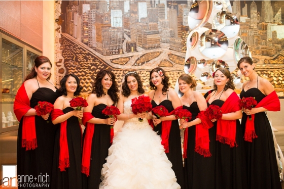Bridesmaids wearing black dresses and red bouquets at Hoboken Wedding